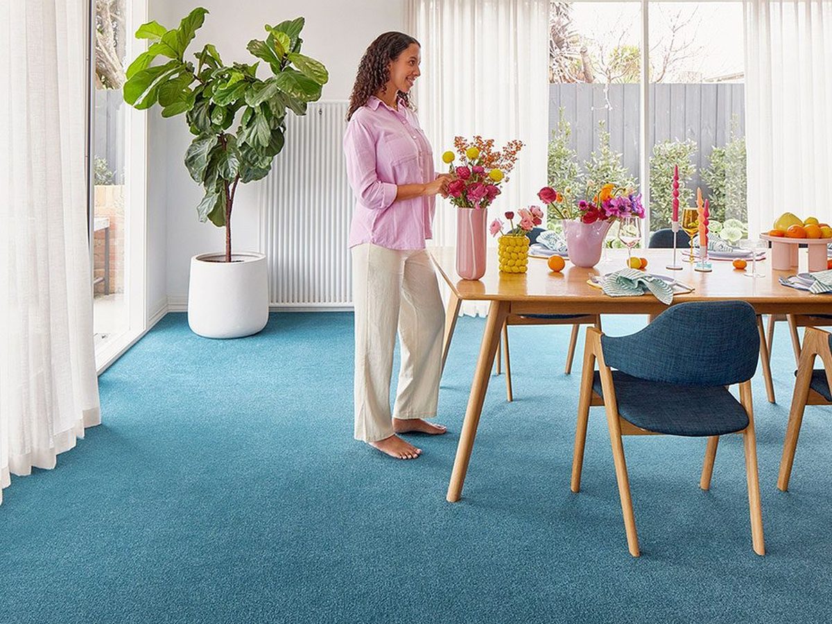 A dining room with blue carpet